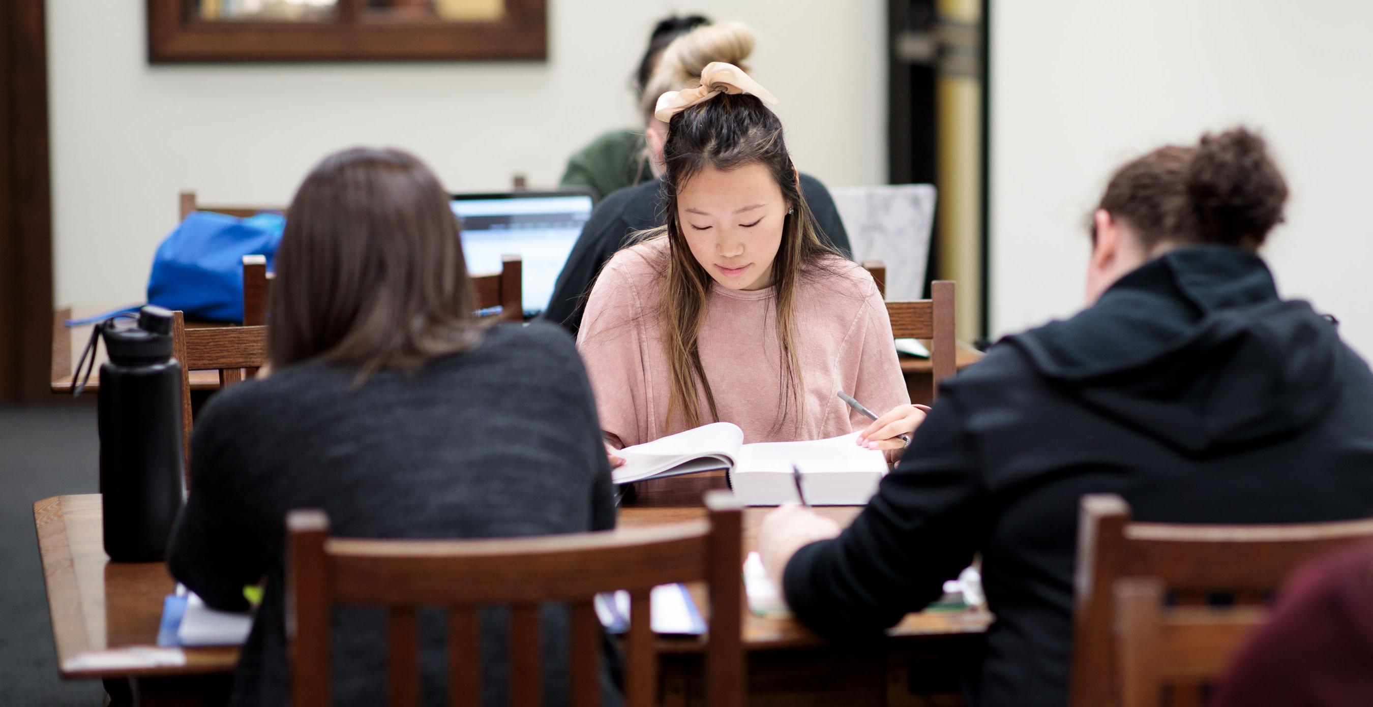 Students studying for exams in the library on campus.